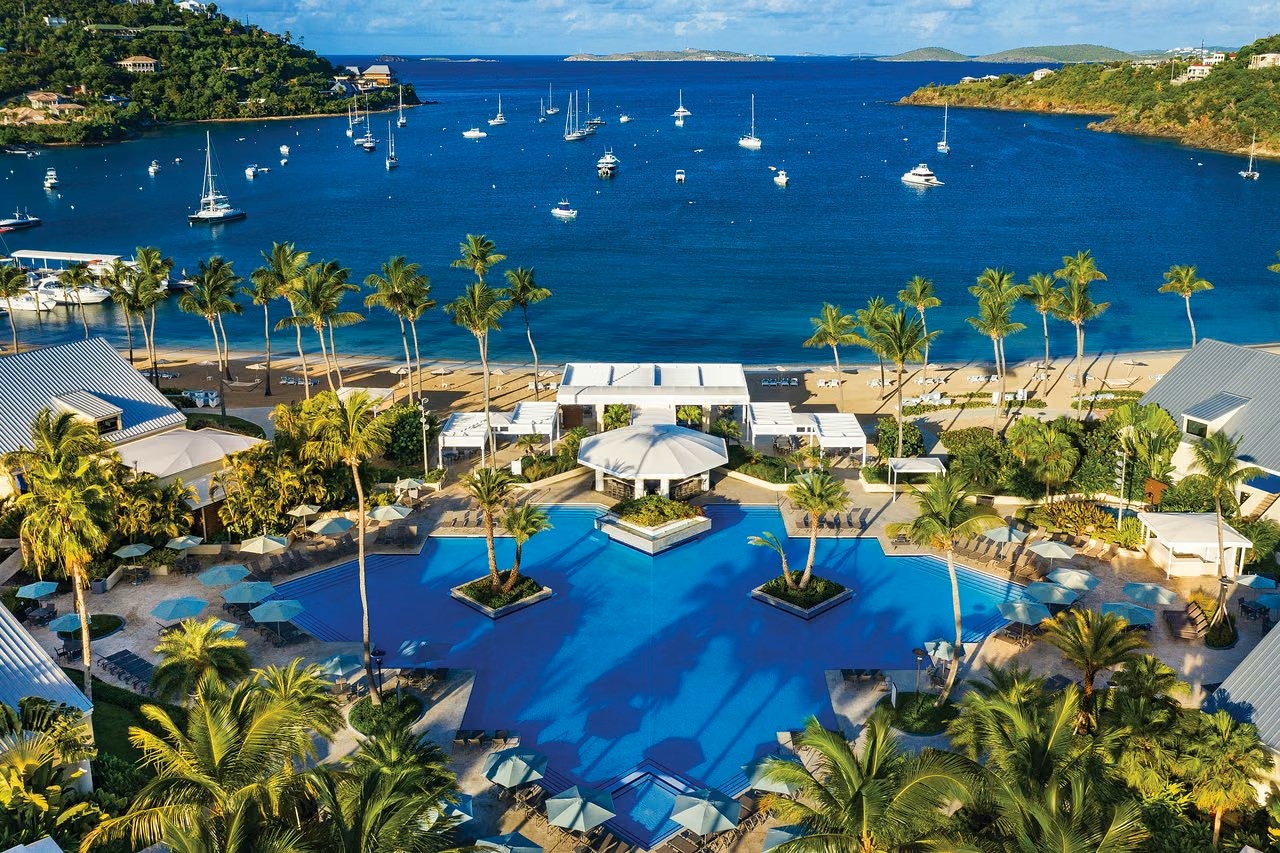 Resort-style pool, palm-lined beach, and stunning bay views