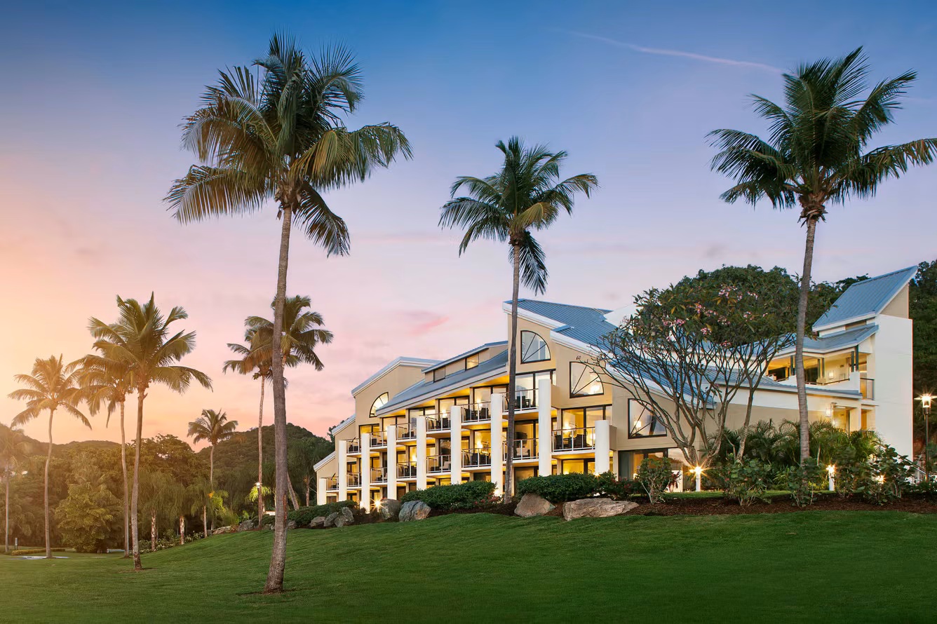 Tropical resort retreat with palm trees, sunset views, and private balconies