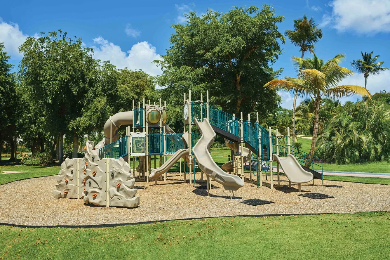 Spacious tropical playground with slides and climbing fun for families