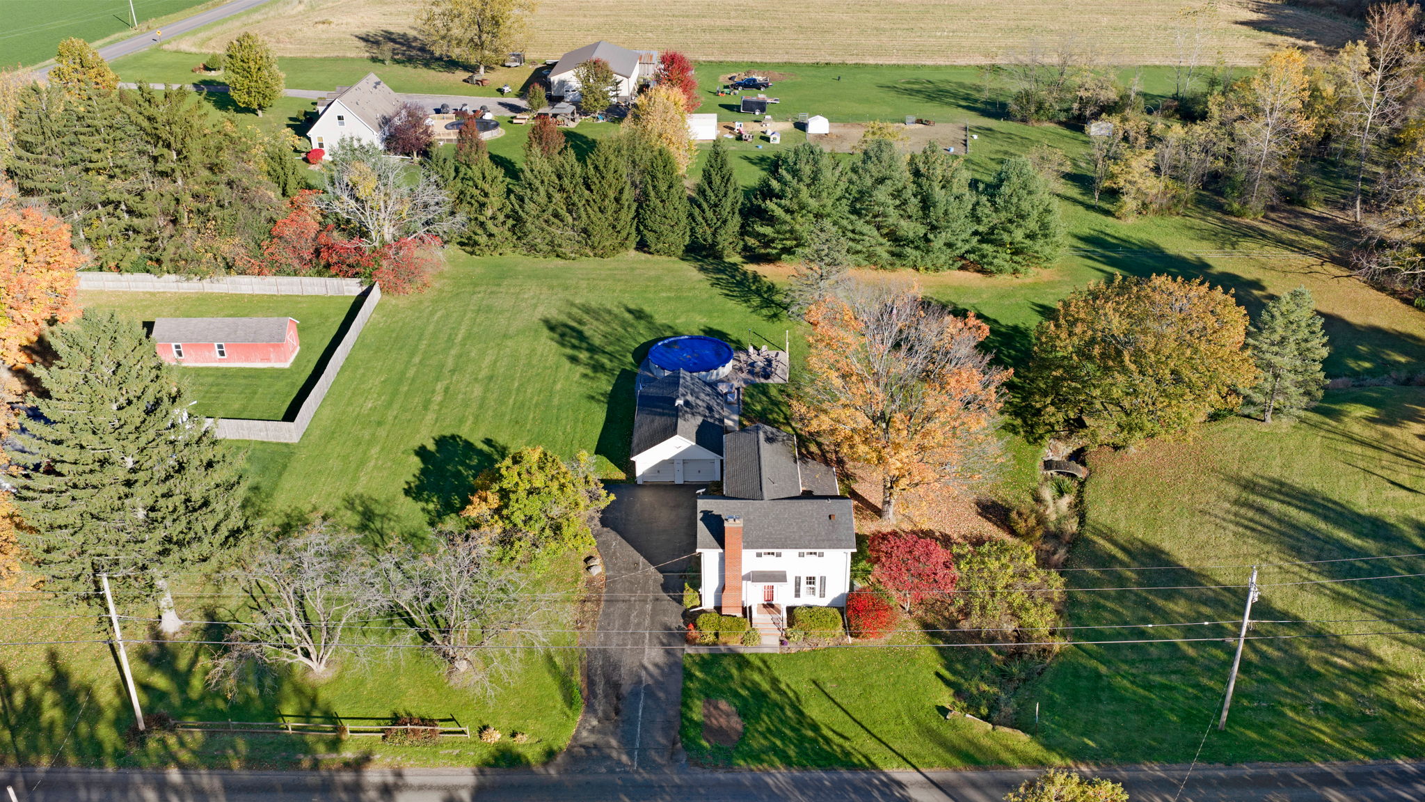 Sprawling country retreat with pool, mature trees, and expansive yard