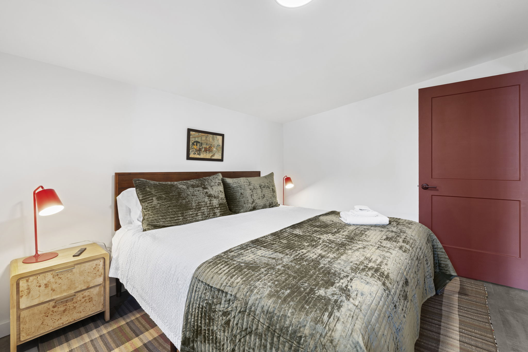 Bright, cozy bedroom with plush king bed and stylish modern accents