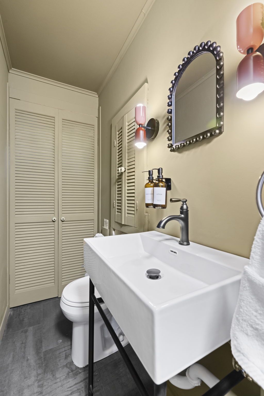 Chic bathroom with modern sink, designer lighting, and built-in storage