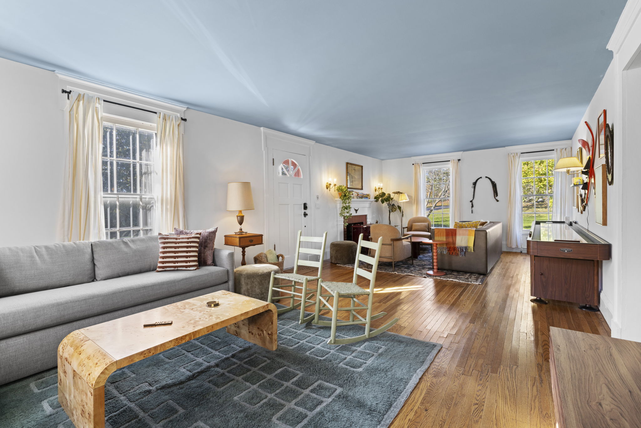 Bright, spacious living room with hardwood floors and cozy seating