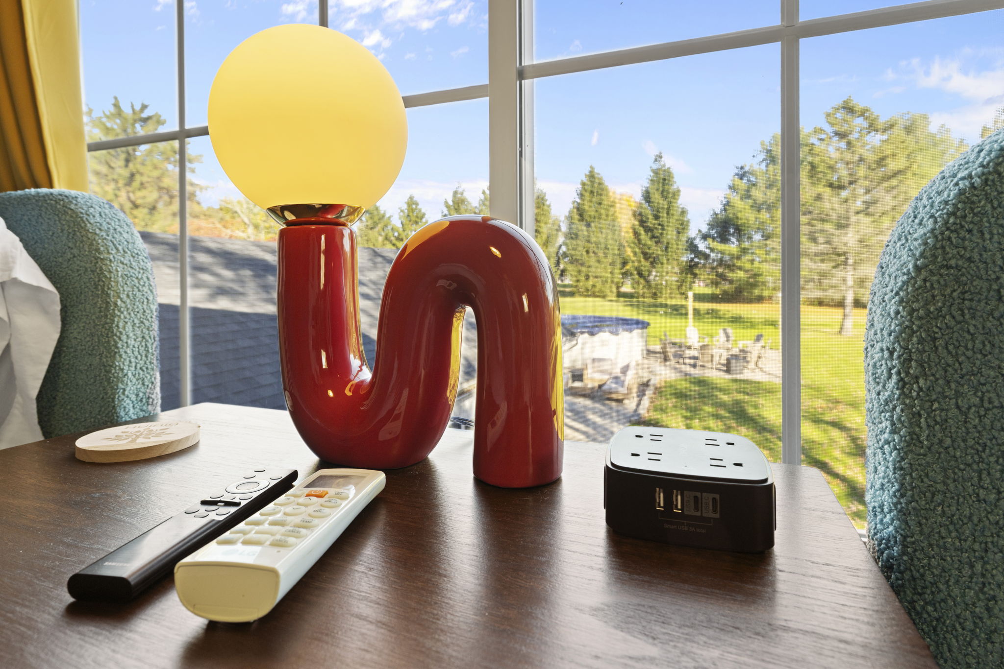 Bright window-side setup with modern lighting and serene backyard views