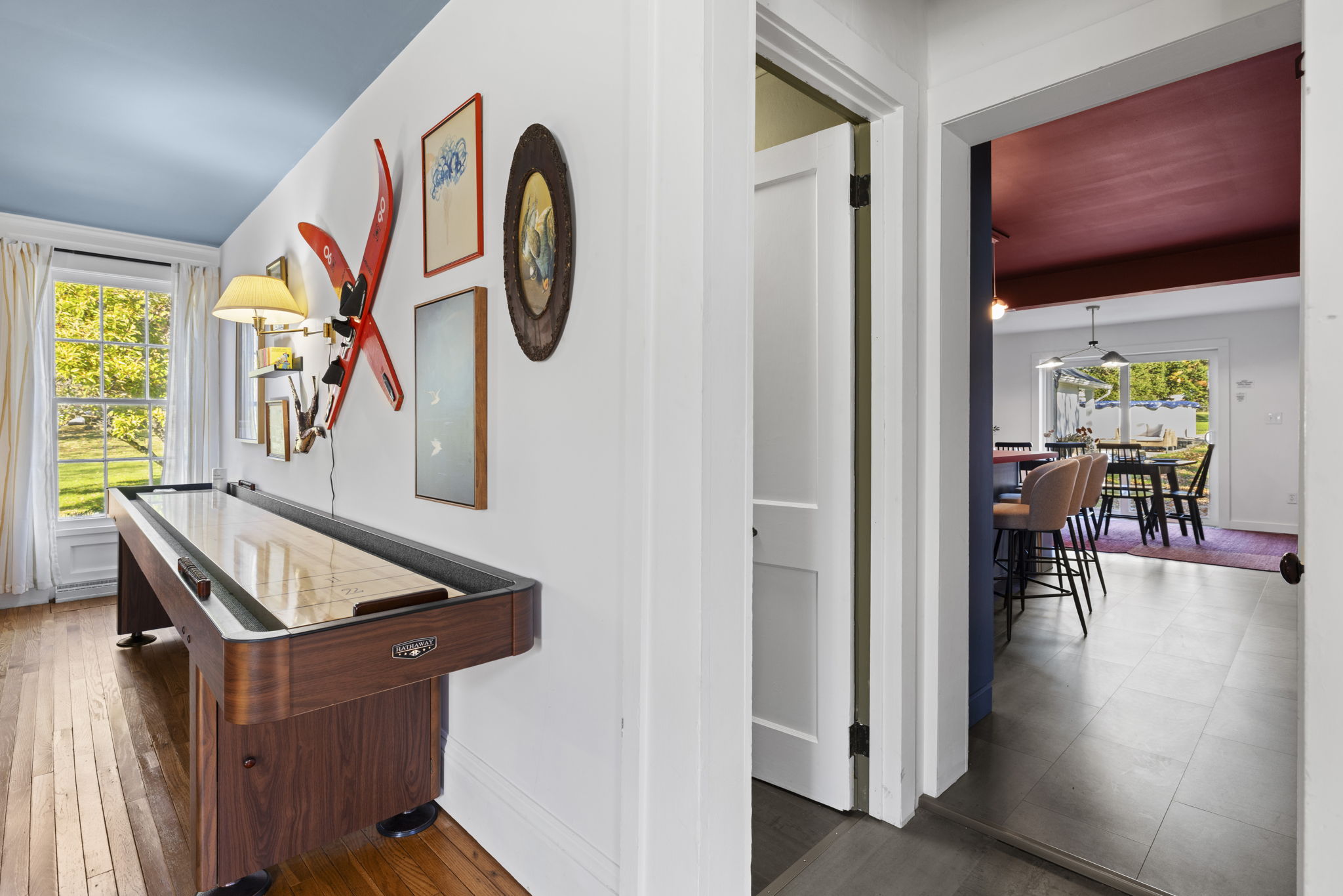 Vintage shuffleboard nook with natural light and playful lodge-style charm