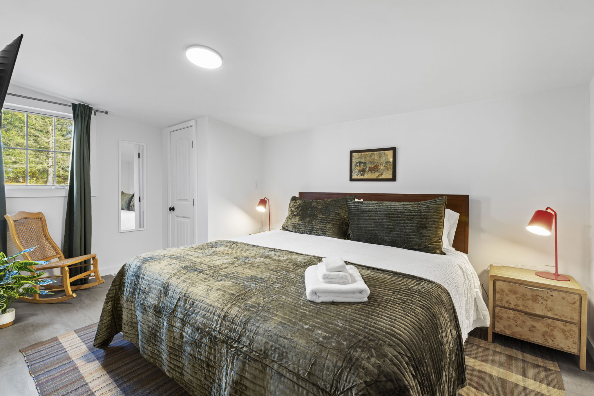 Bright, cozy bedroom with plush king bed and relaxing seating area