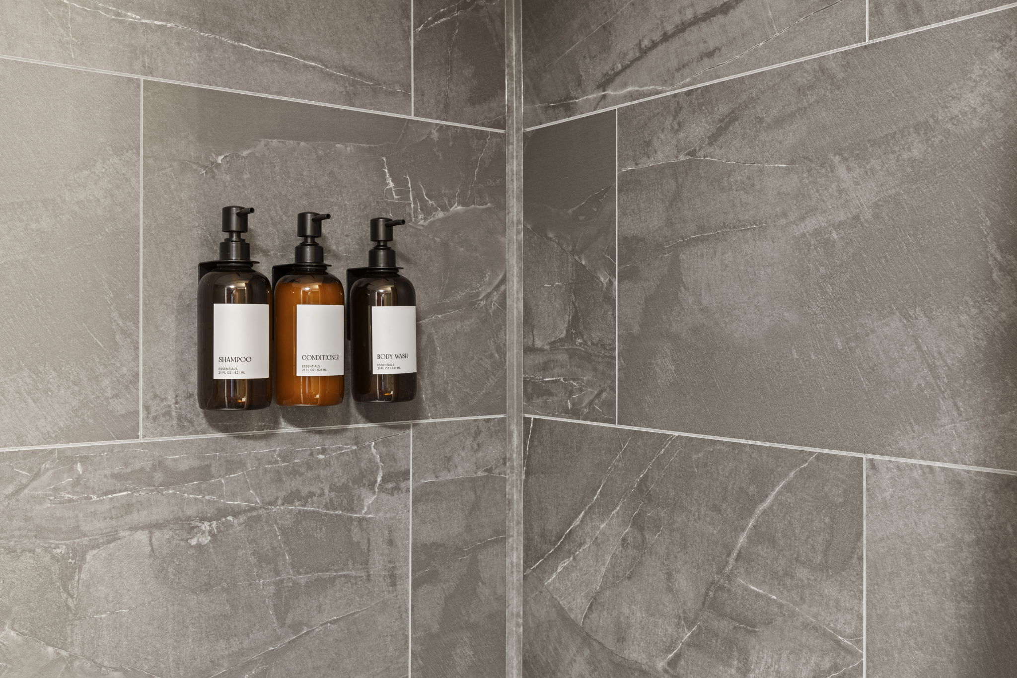 Modern tiled shower with built-in niche and premium bath amenities
