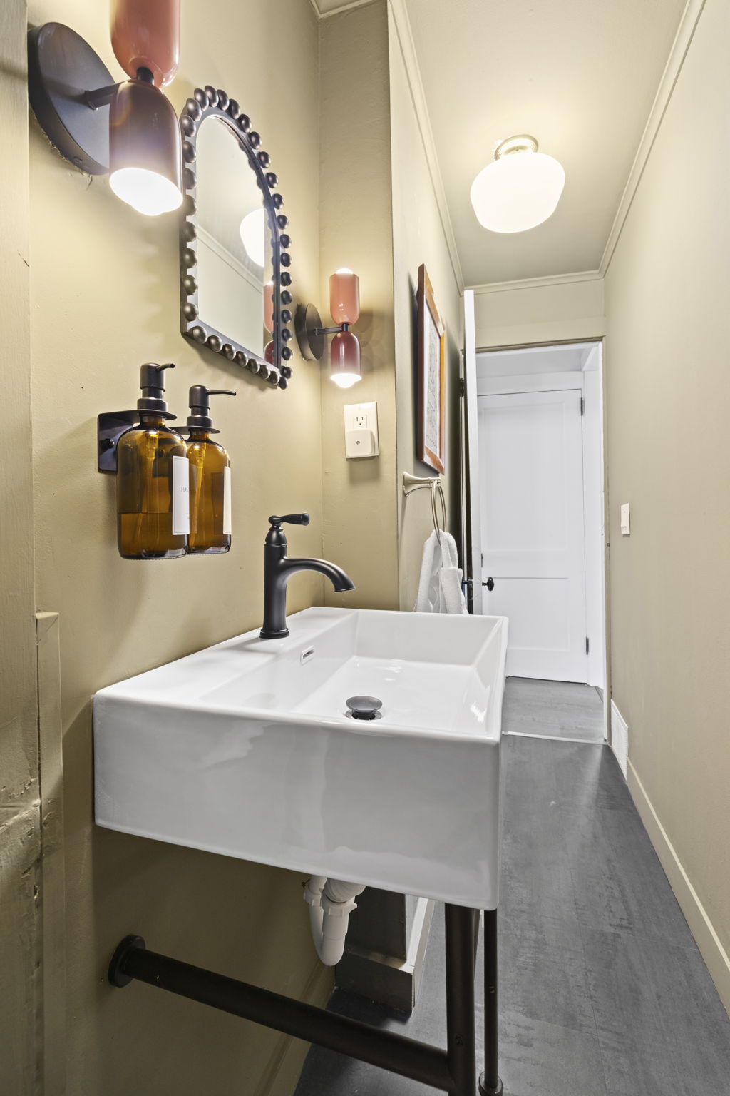 Stylish powder room with modern sink, designer lighting, and chic details