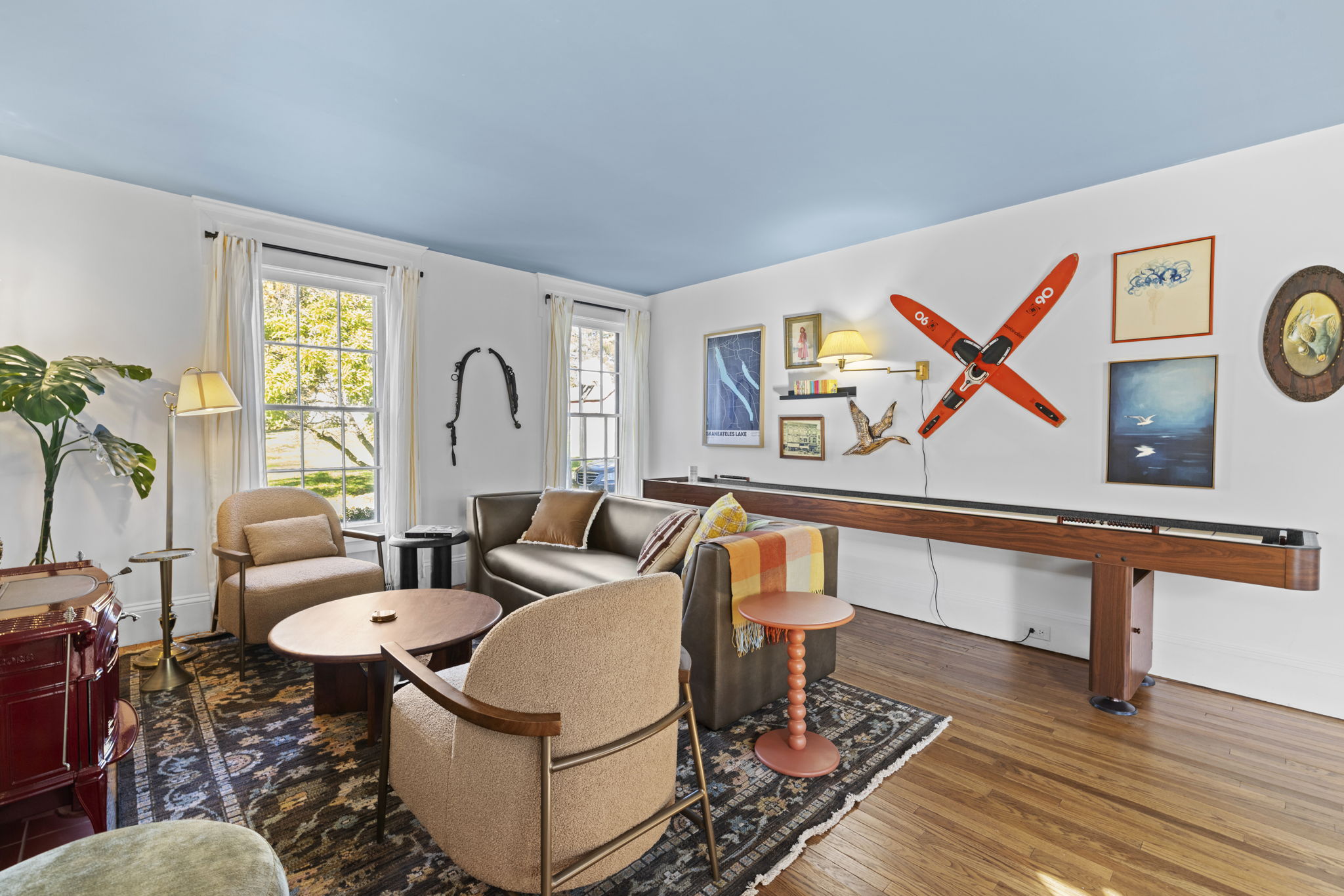 Bright lounge with shuffleboard, large windows, and stylish decor