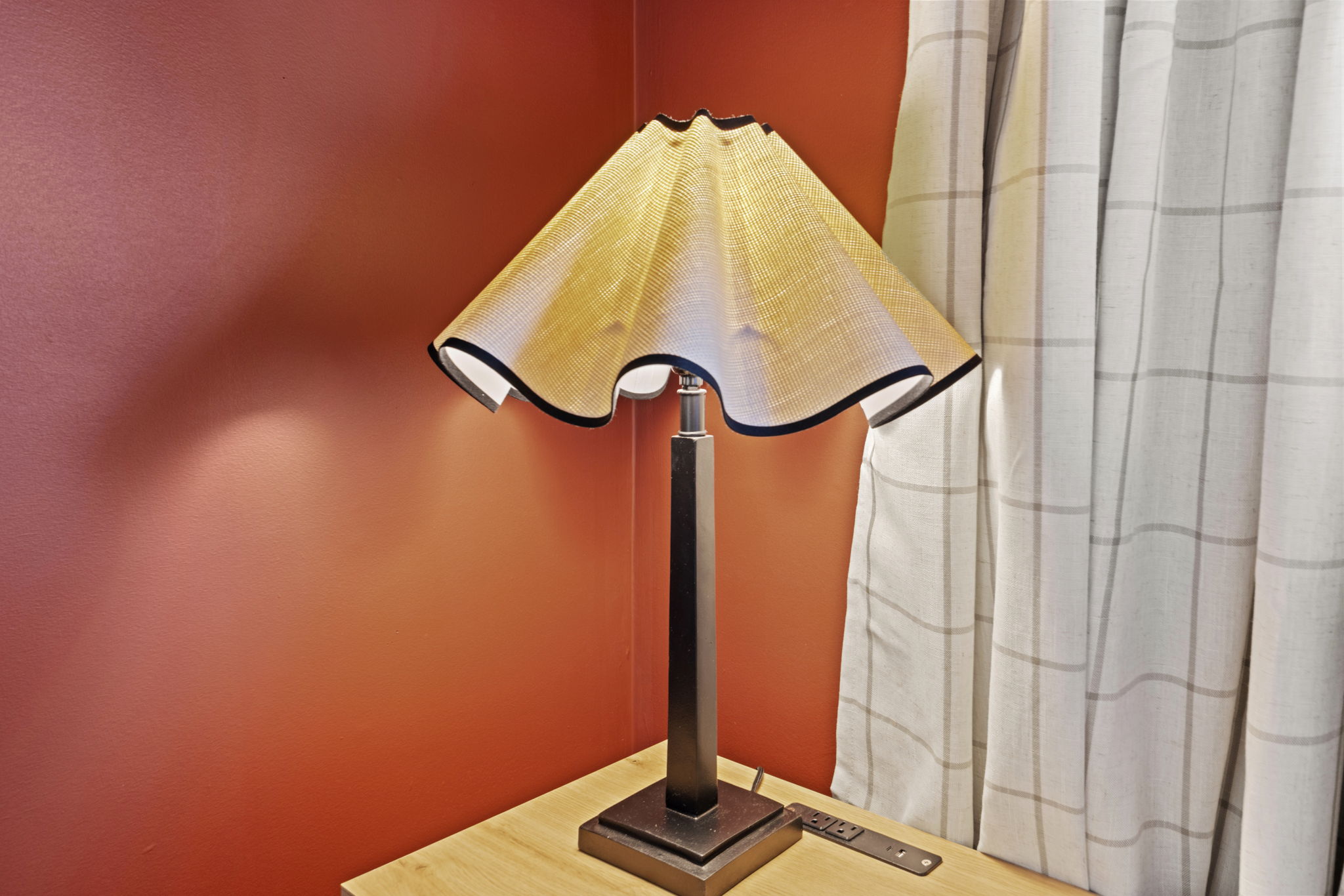 Warm reading lamp with cozy accents and convenient bedside power access