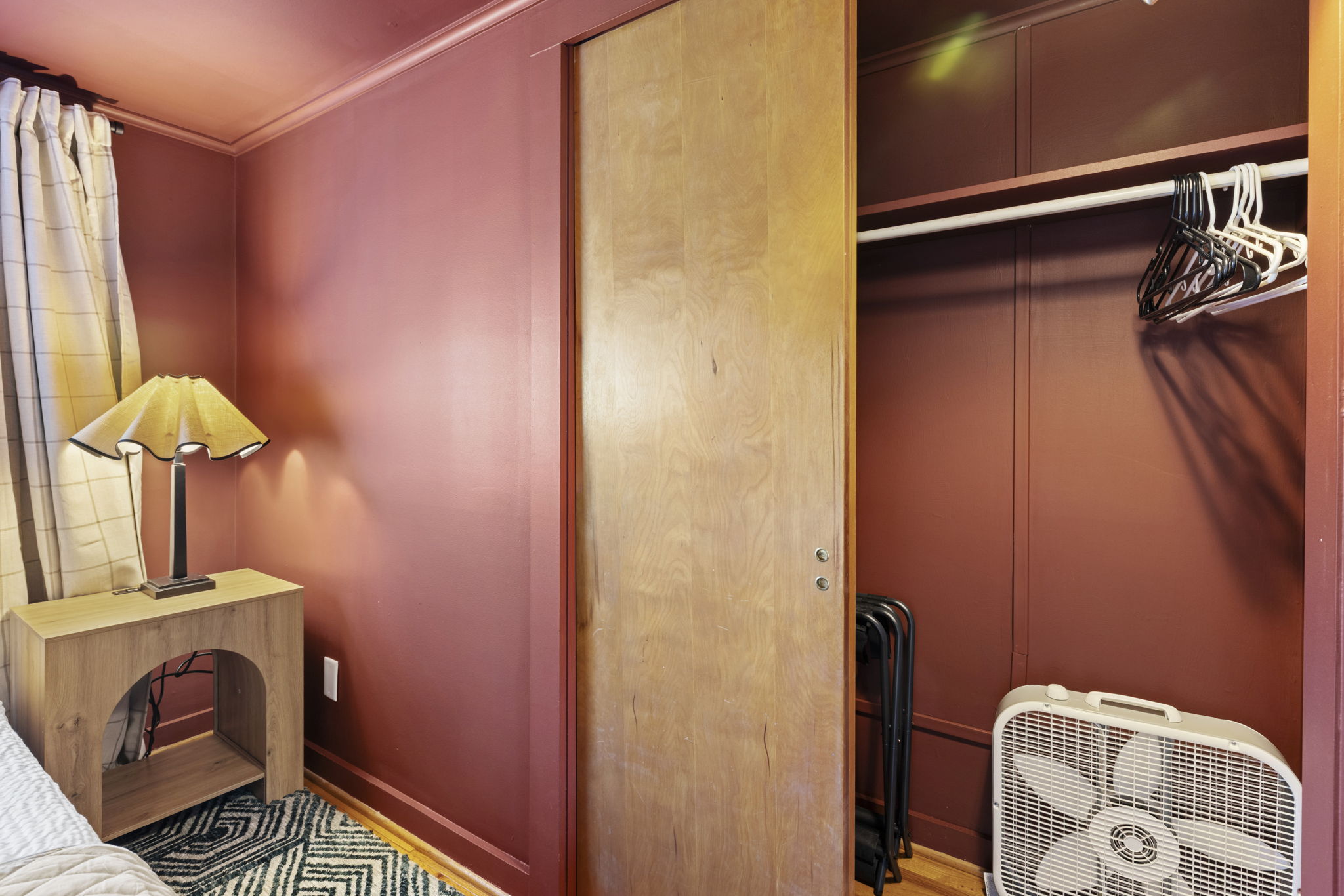 Cozy bedroom corner with built-in closet and warm, inviting décor
