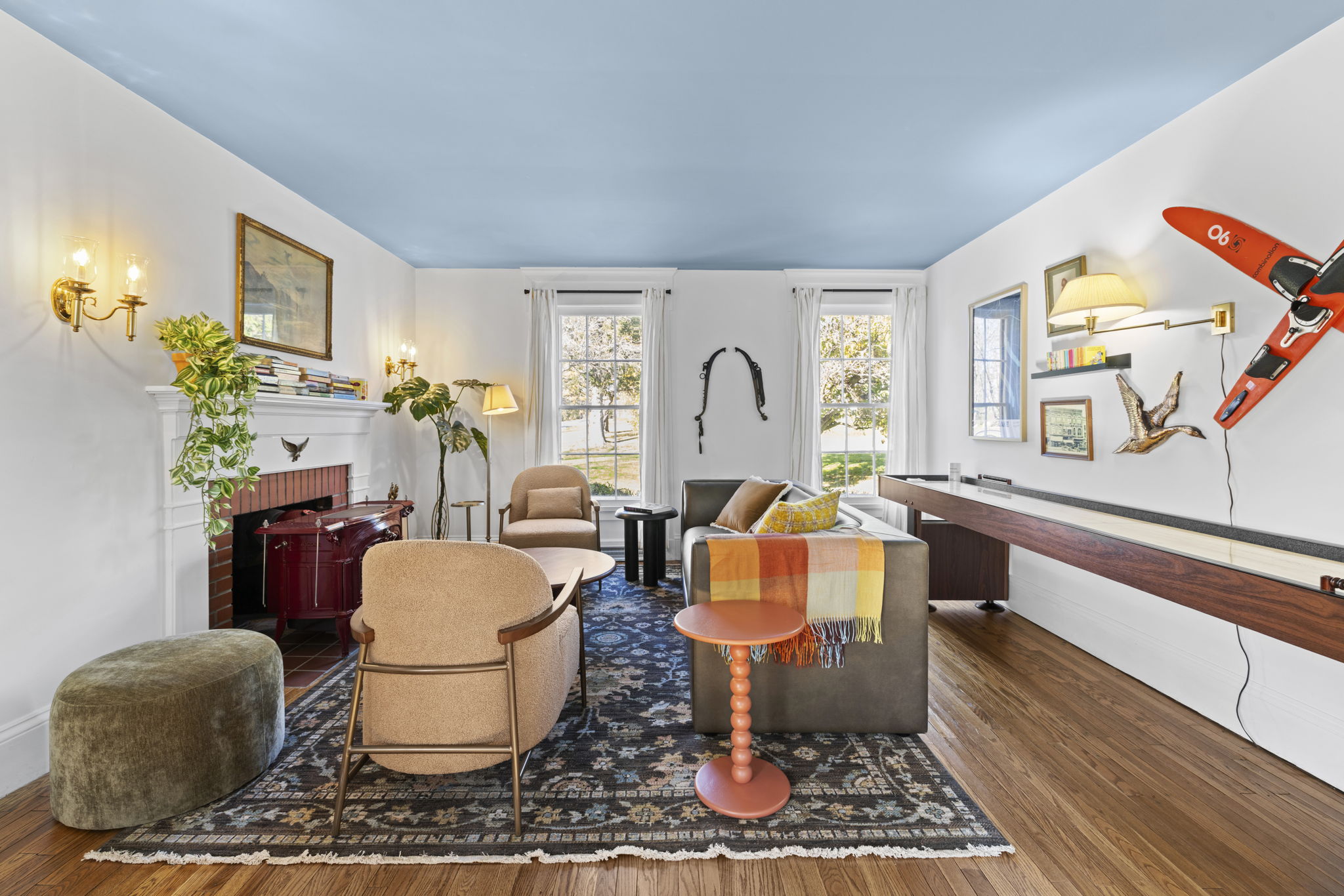 Bright designer living room with fireplace, lounge seating & game table