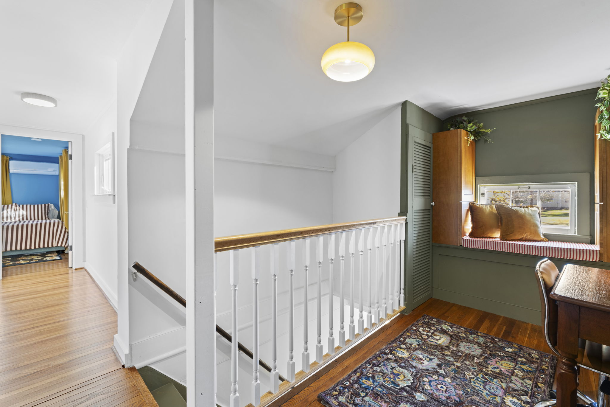 Bright upstairs landing with cozy window seat and charming work nook