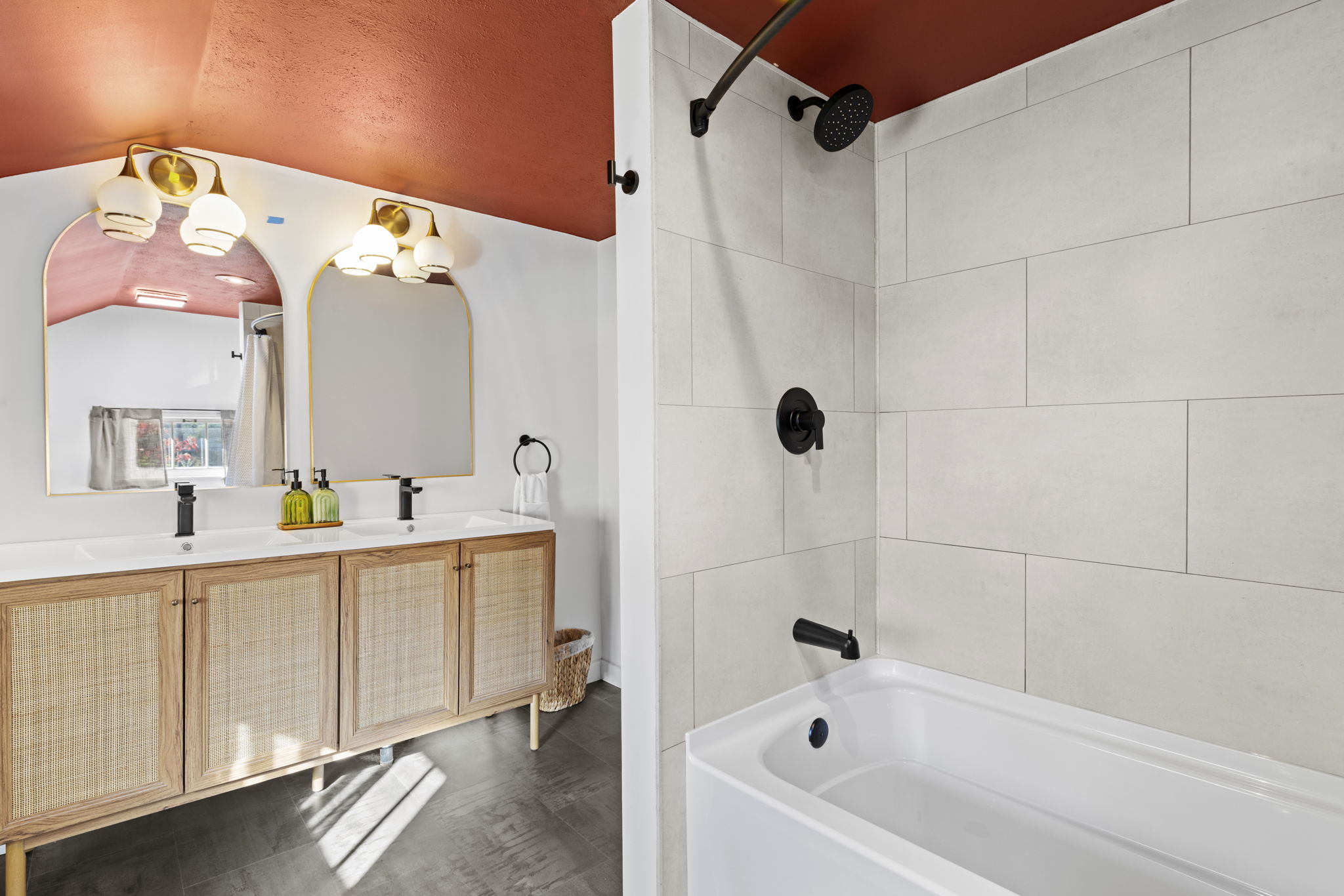 Stylish bath with double vanity, arched mirrors & tiled tub-shower