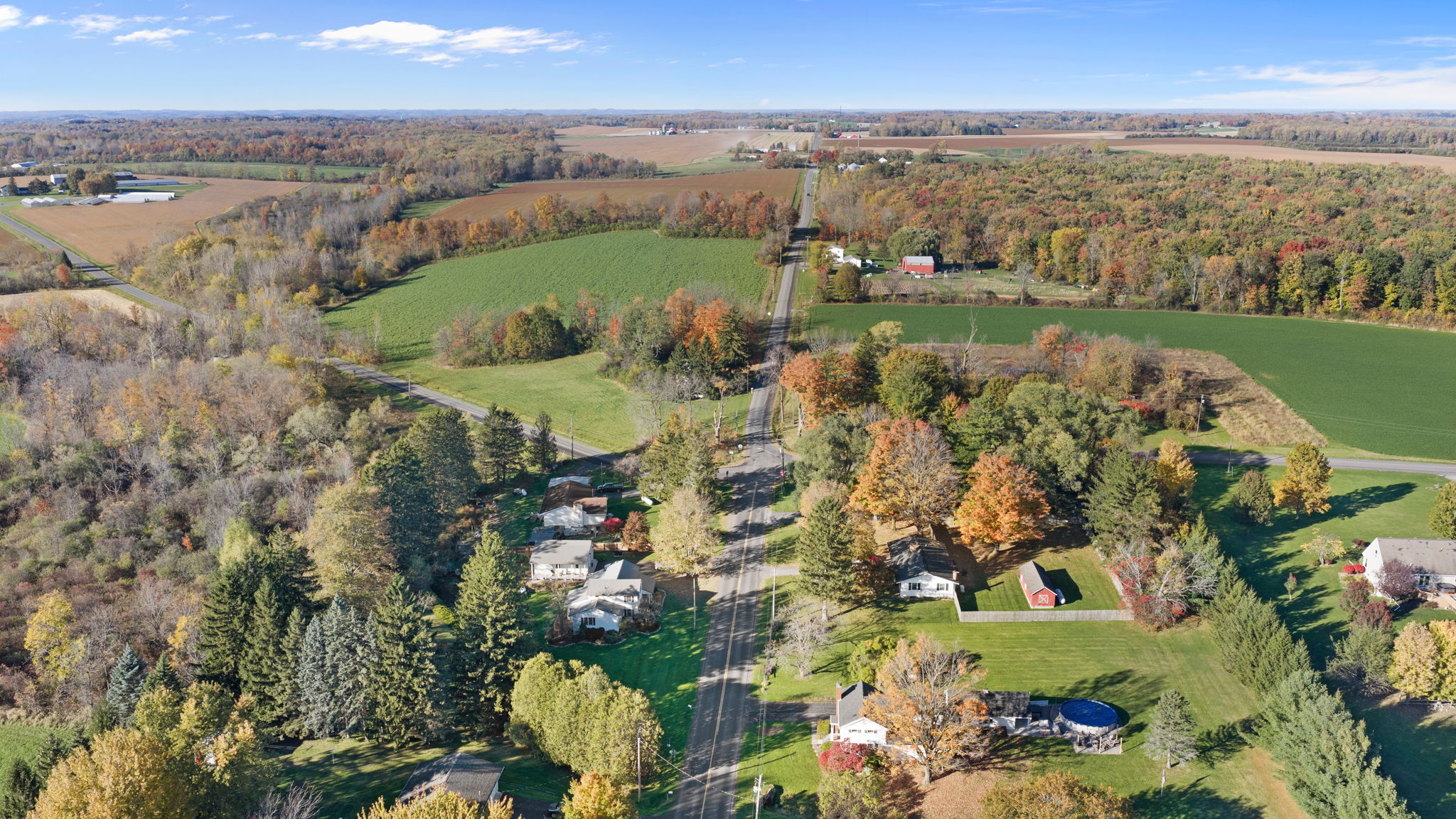 Peaceful countryside retreat surrounded by open fields and fall foliage