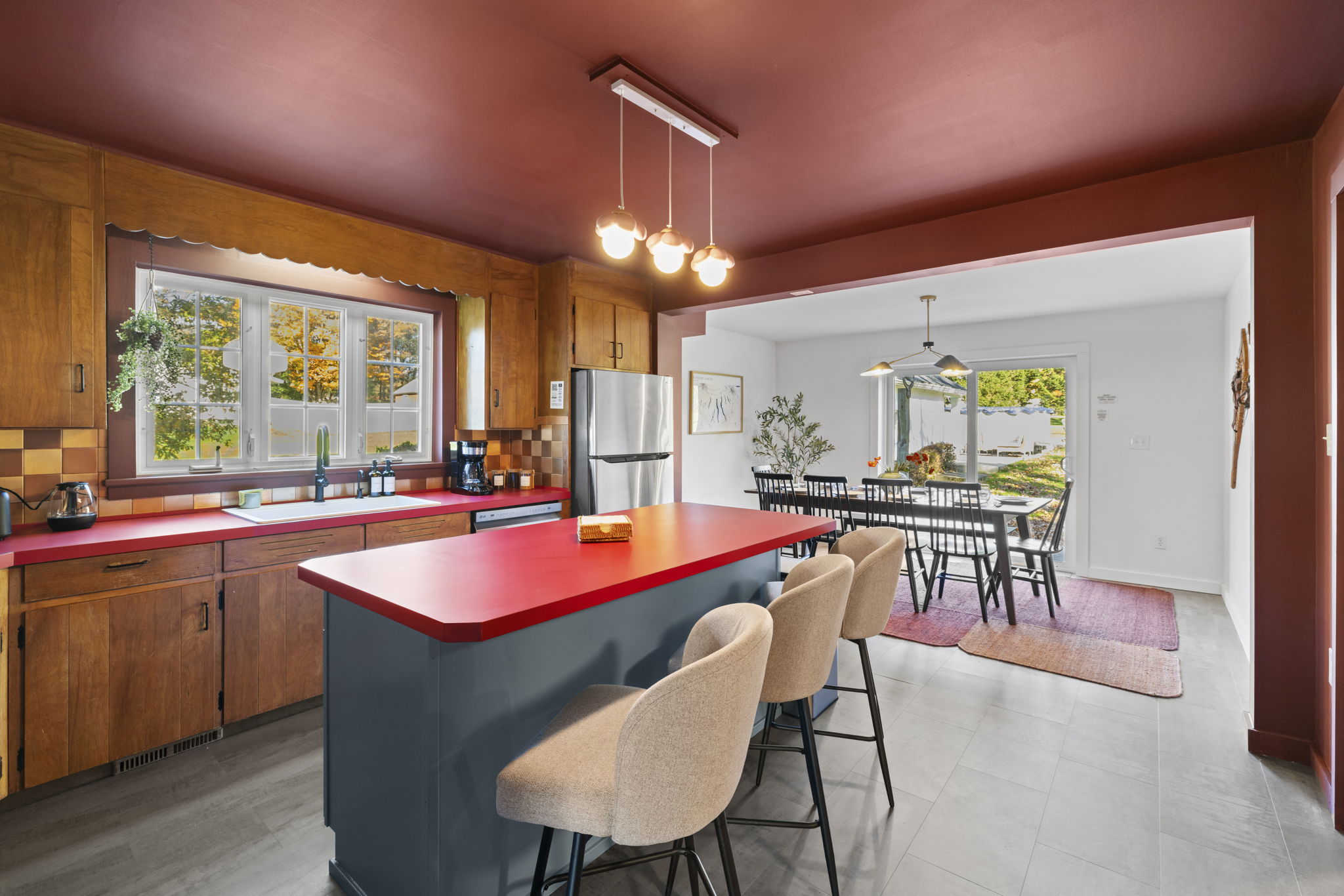 Open kitchen with bold island seating and bright dining area