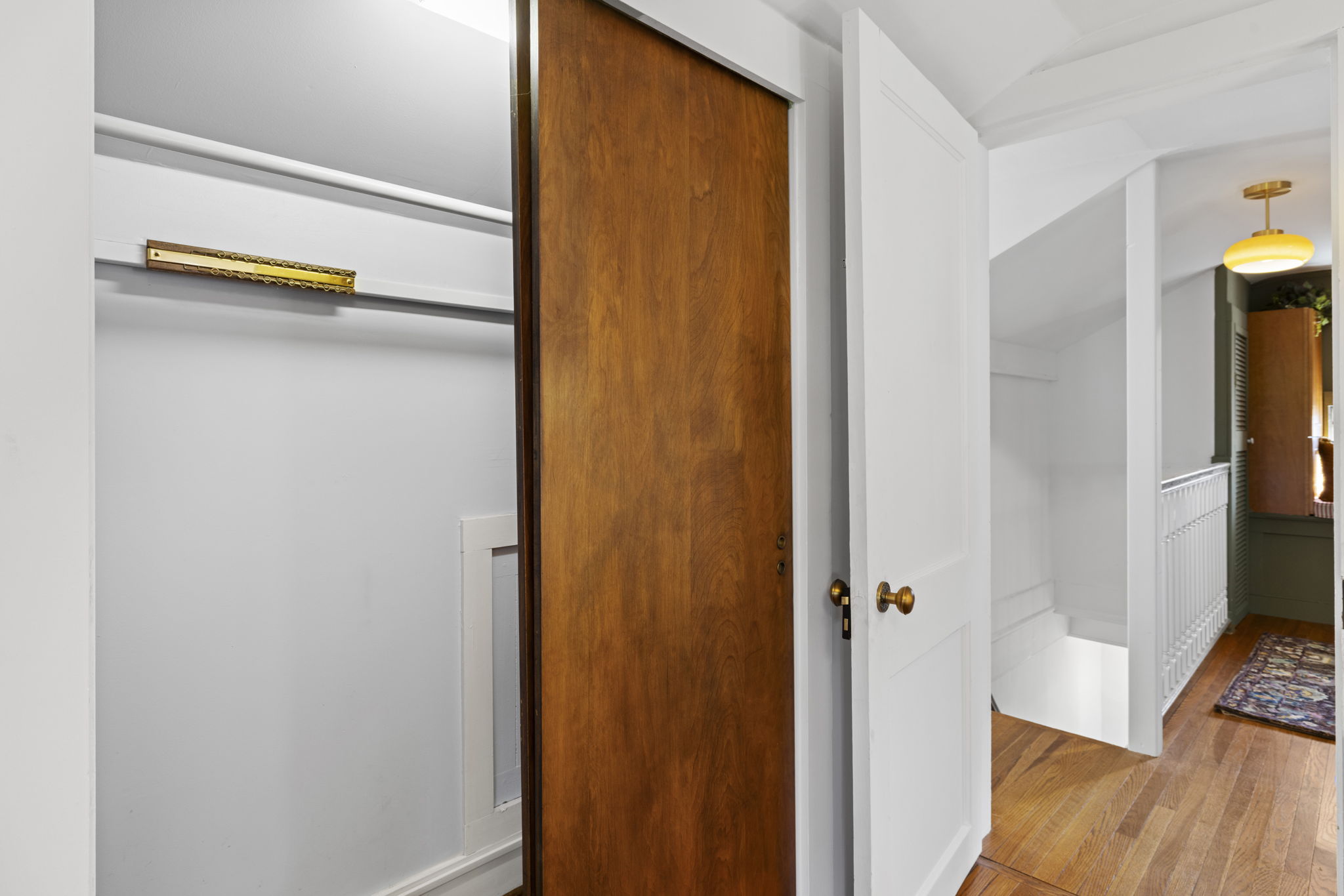 Bright hallway with built-in closet and charming wood details