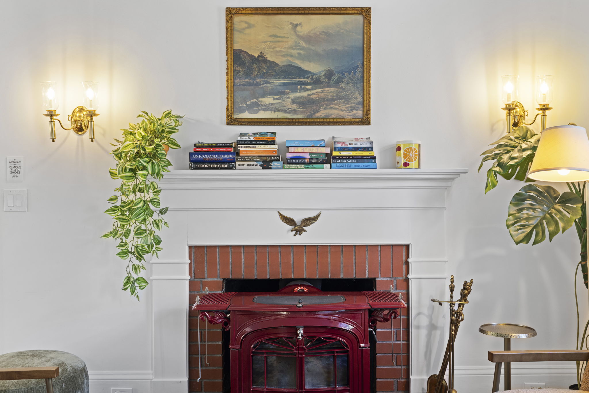 Charming fireplace nook with vintage style, warm lighting, and curated decor
