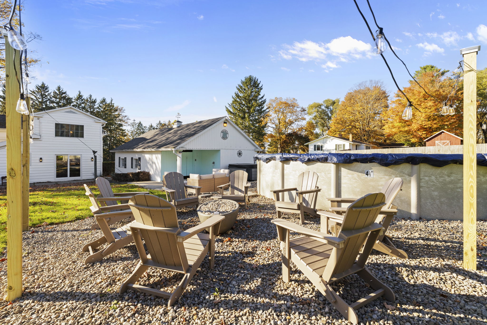 Relax by the fire pit and enjoy the pool in this spacious backyard retreat