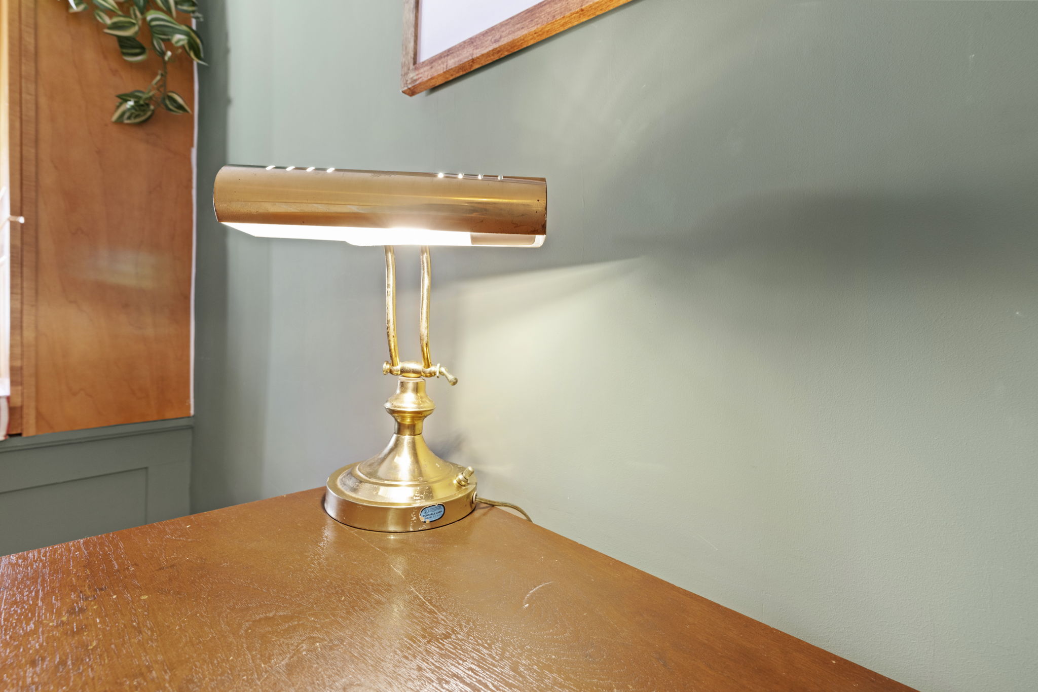 Classic brass desk lamp adds warm light and timeless charm