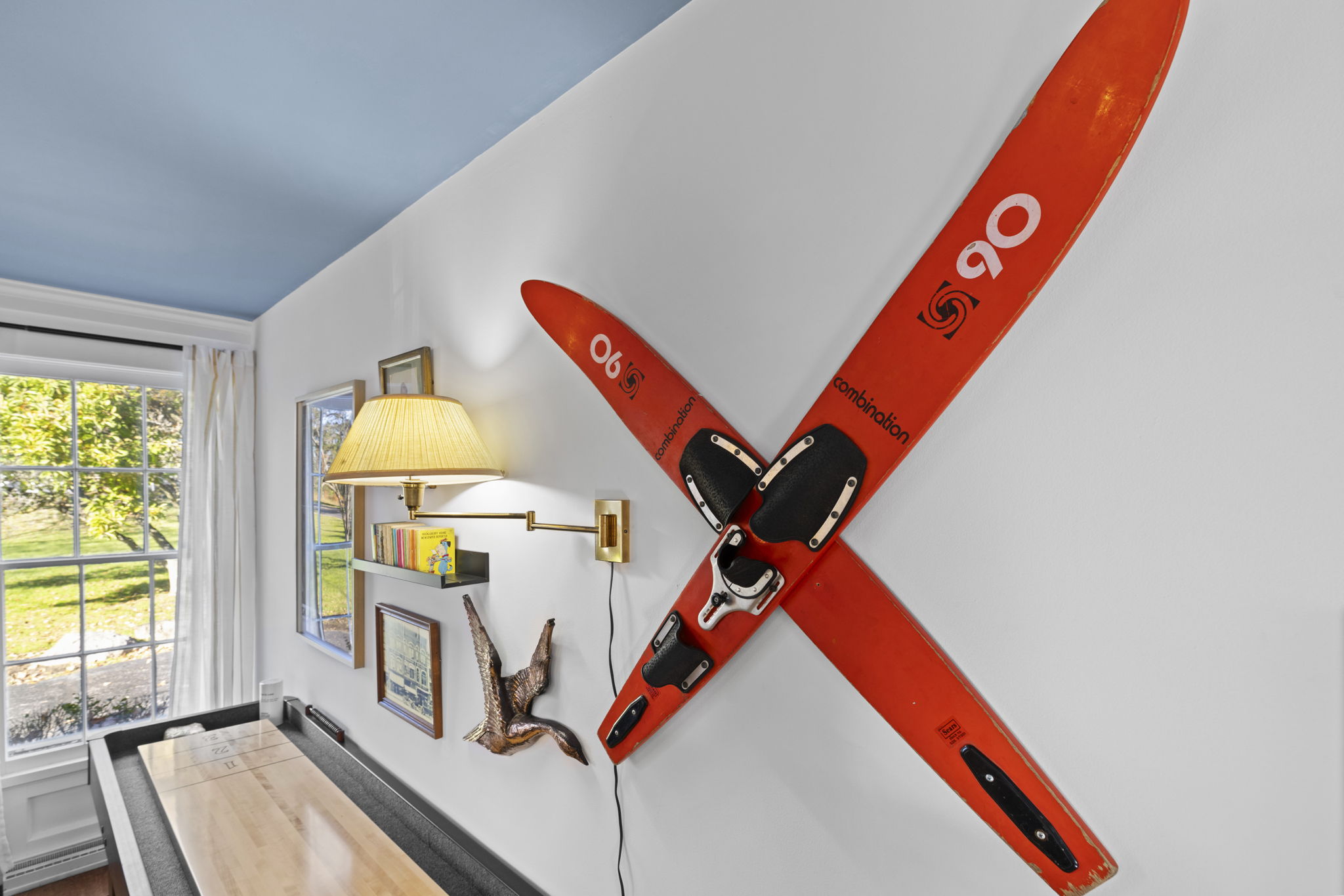 Bright nook with vintage ski wall art and sunny outdoor views