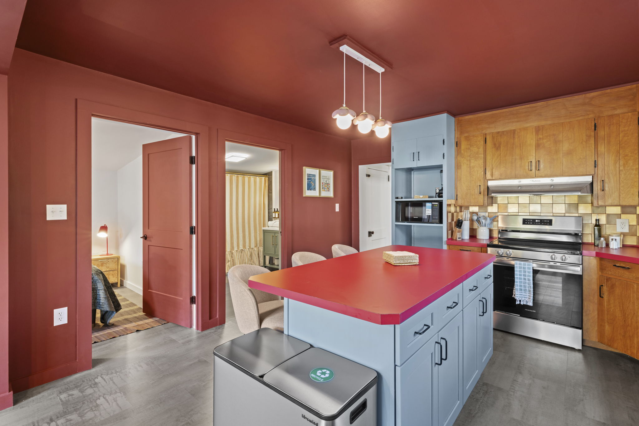 Colorful modern kitchen with island seating and stainless appliances