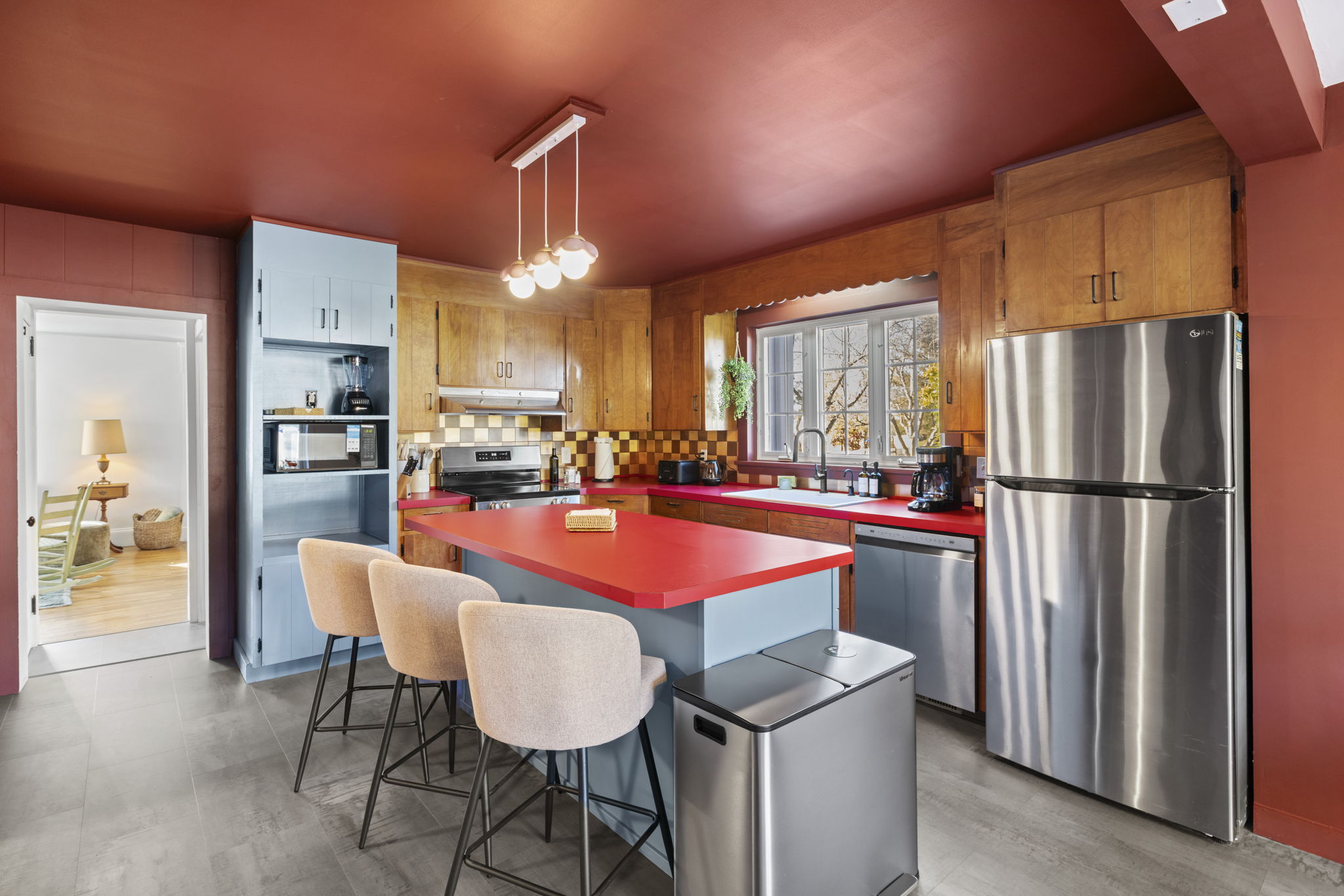 Bold, stylish kitchen with island seating and stainless steel appliances