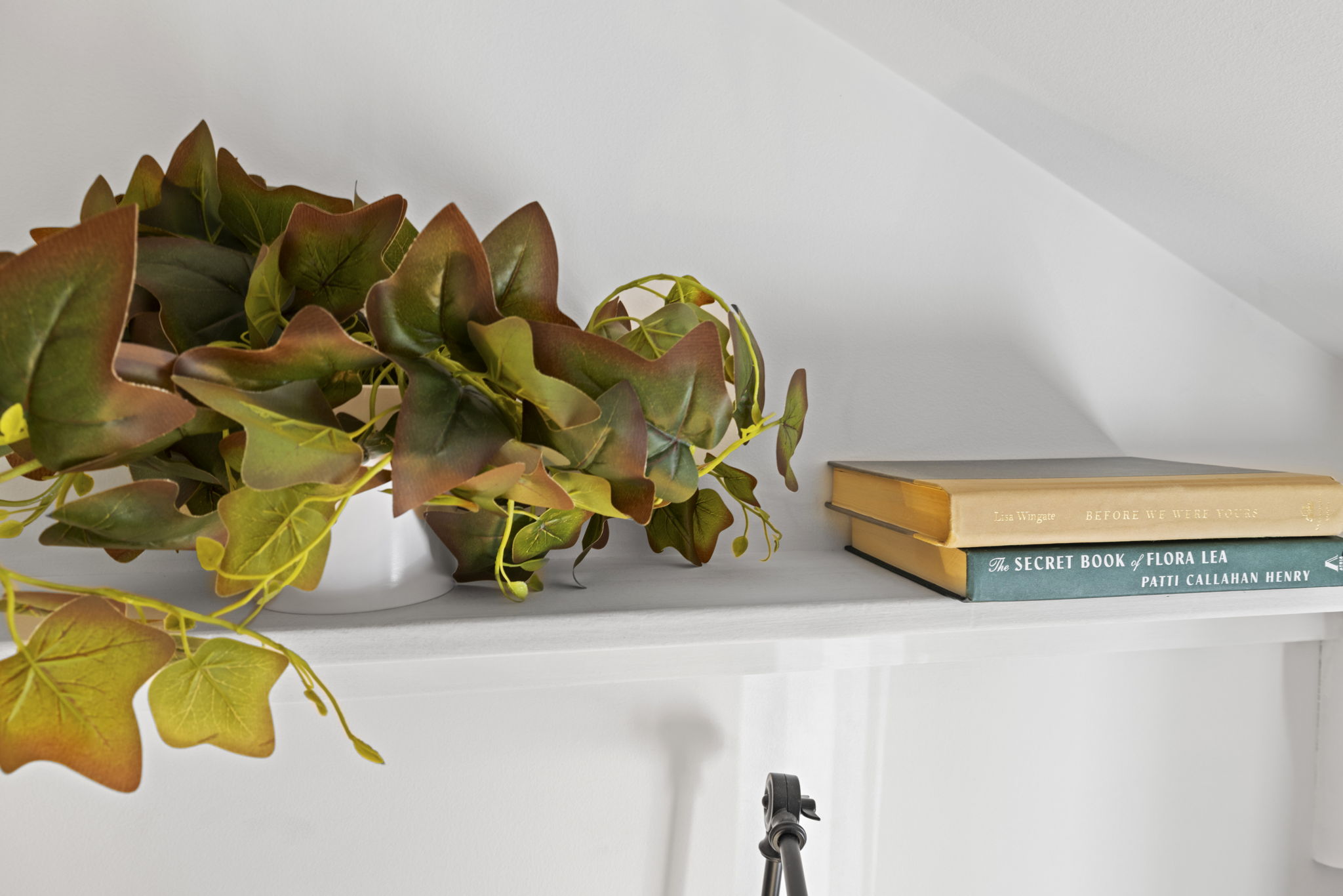 Thoughtfully styled shelf with greenery and books for a cozy touch