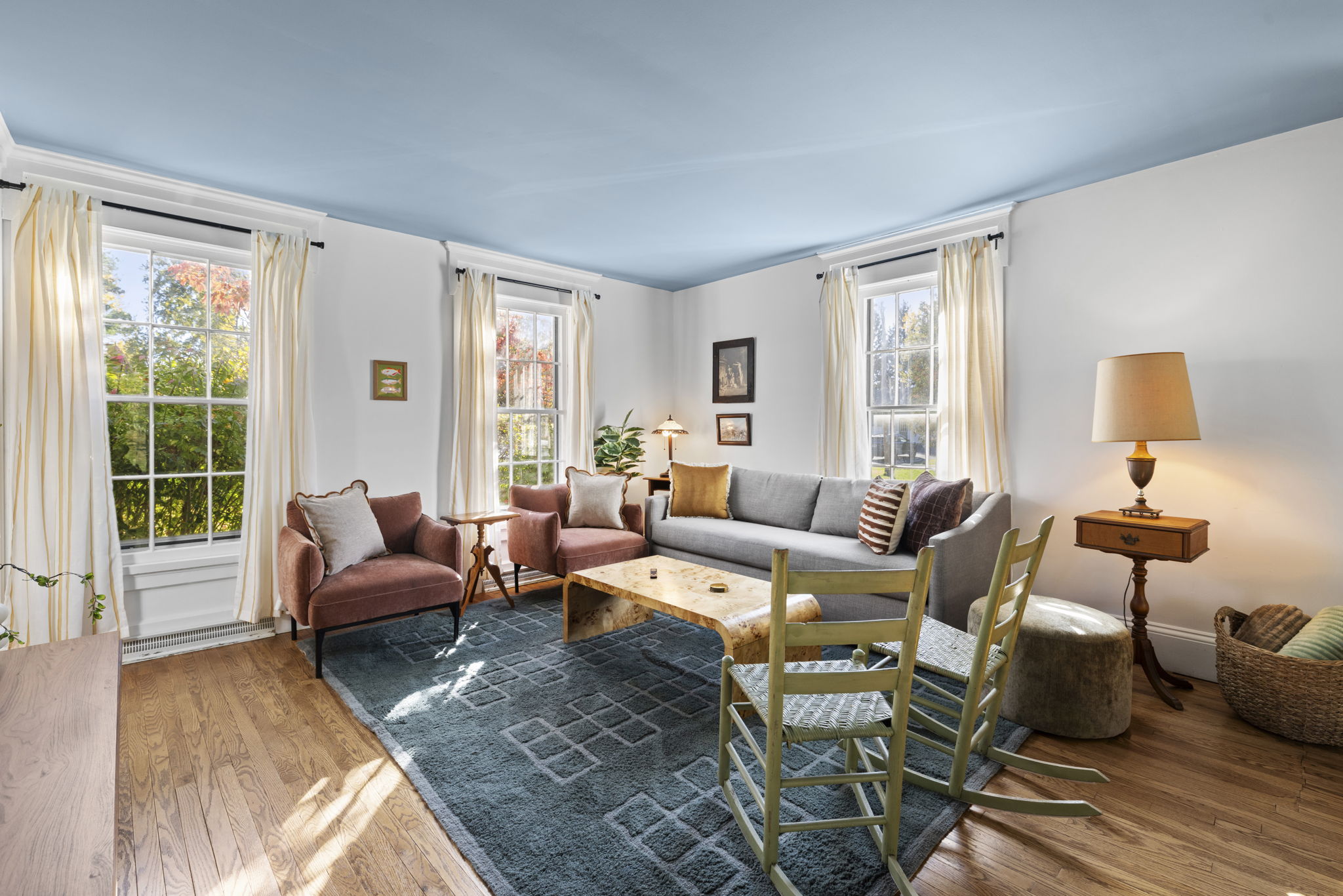 Sunny, cozy living room with generous seating and classic charm