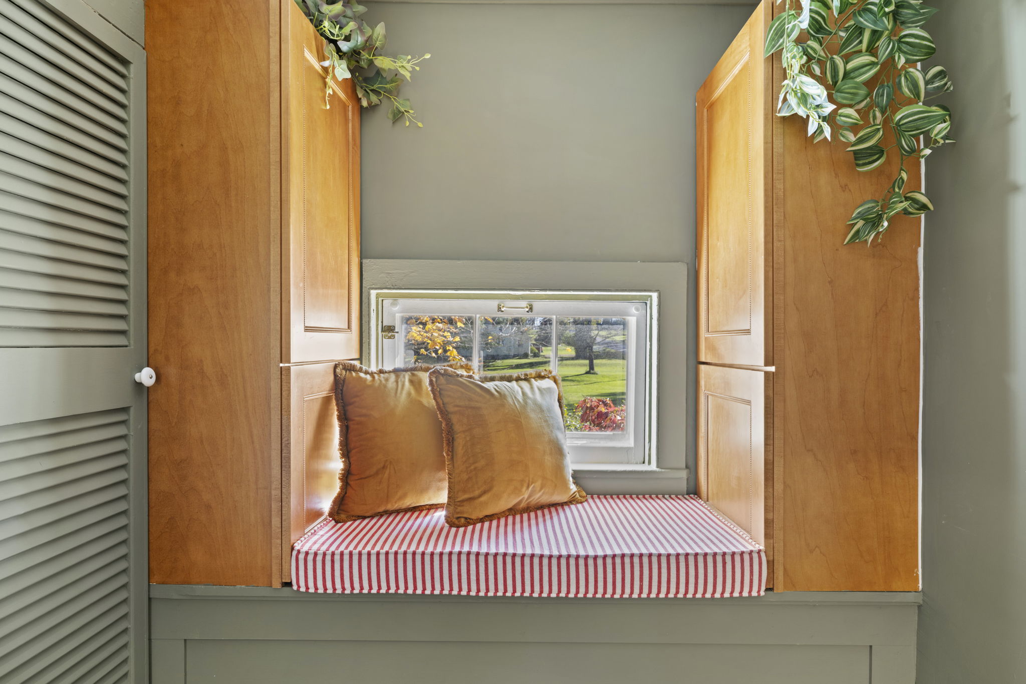 Cozy built-in window seat with storage and peaceful garden views