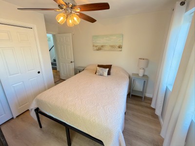 Bright, cozy bedroom with coastal decor and warm natural light
