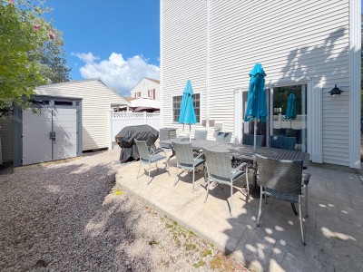 Private patio with outdoor dining, umbrellas, grill & fenced yard
