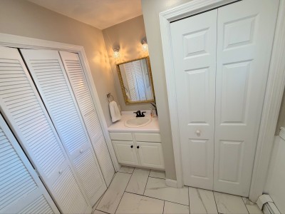 Bright vanity area with ample storage and clean, classic finishes
