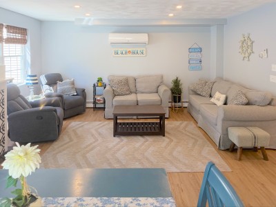 Bright coastal living room with ample seating and a cozy, inviting feel
