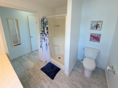 Bright coastal bathroom with walk-in shower and spacious layout