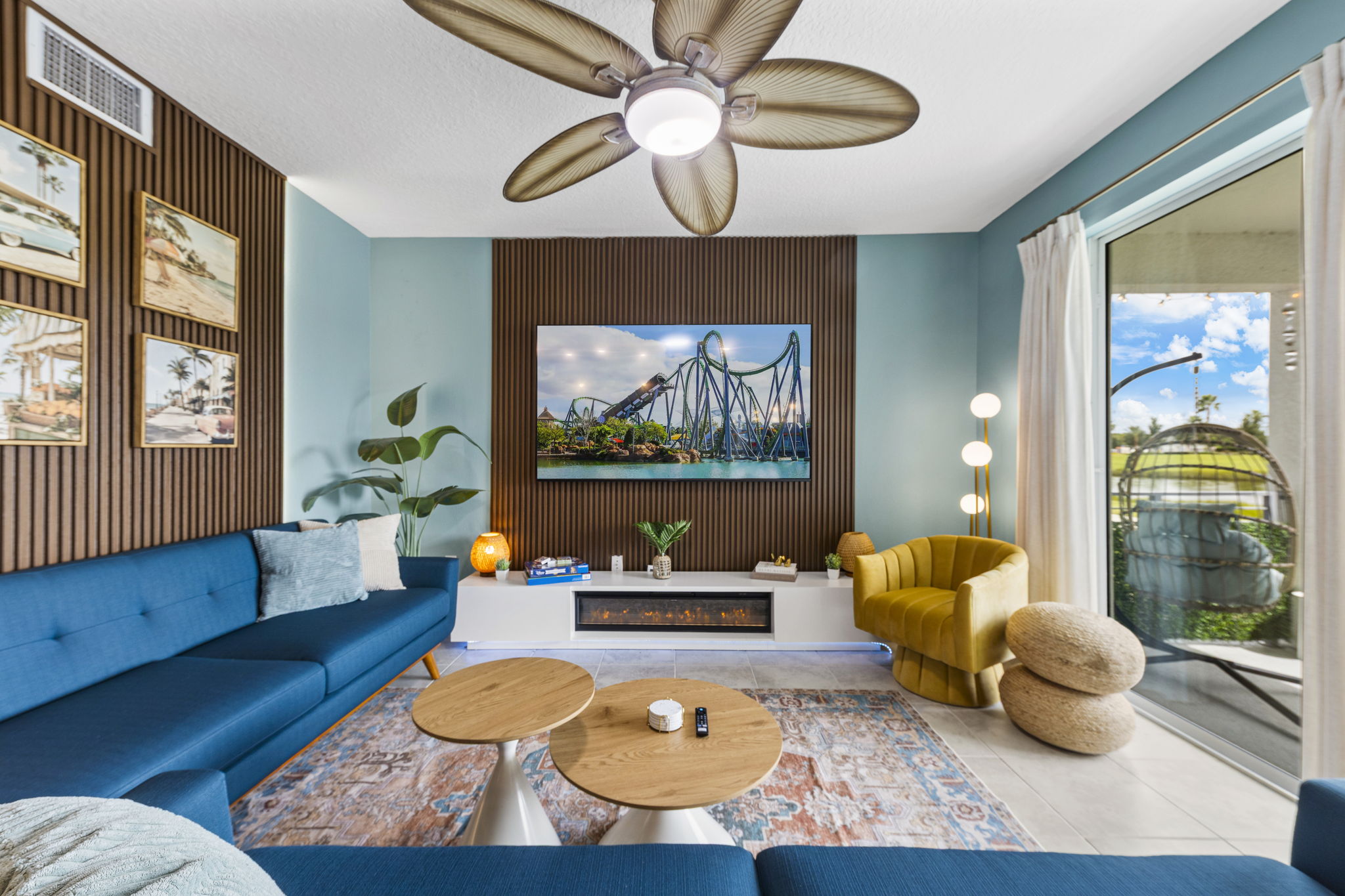 Bright coastal living room with fireplace, patio access, and stylish seating