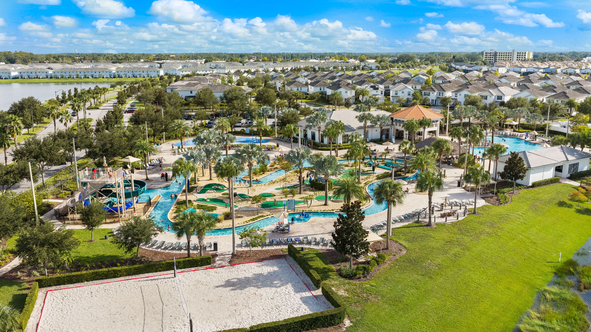Resort-style pools, lazy river, splash zone, and sand volleyball