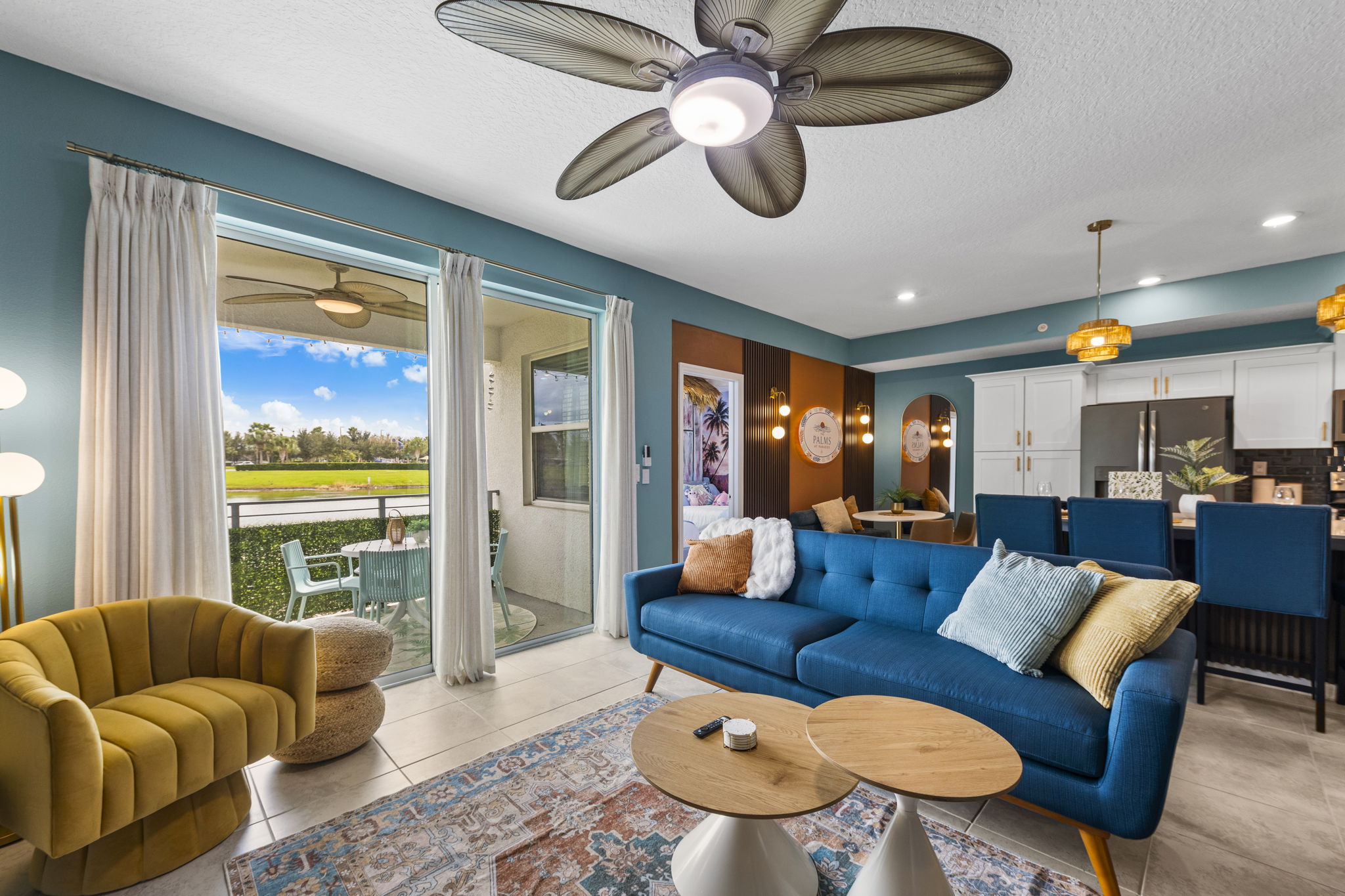 Stylish waterfront living room with screened patio and modern coastal flair