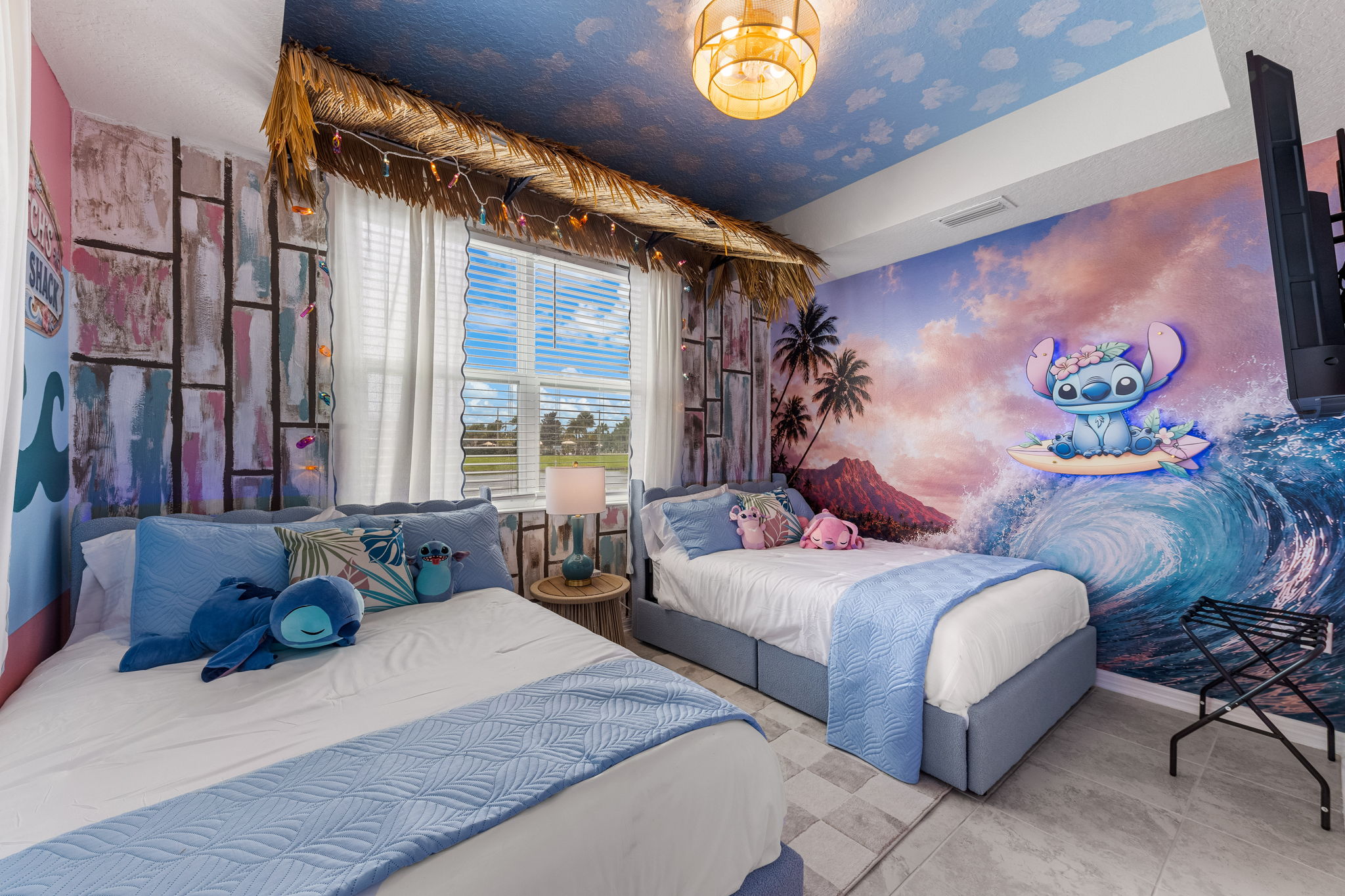 Stitched themed double bedroom with vibrant mural and fun family-friendly style