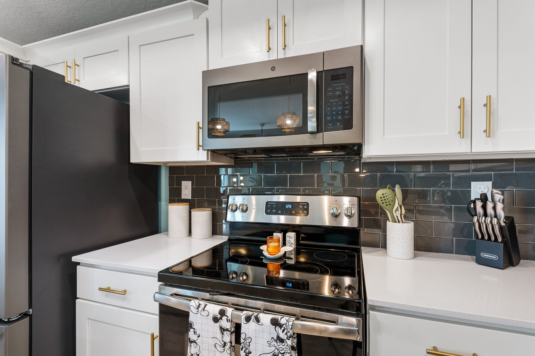 Sleek modern kitchen with stainless appliances and stylish black tile