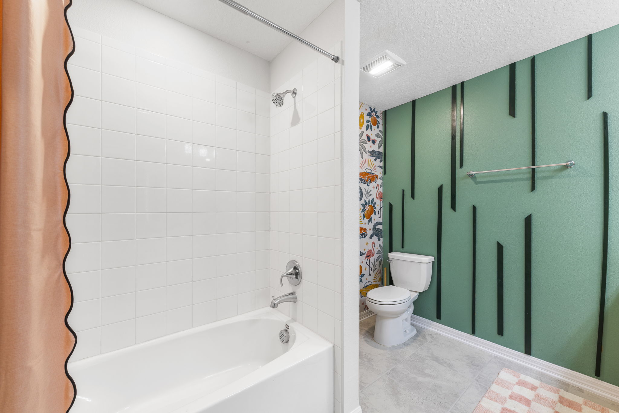 Stylish bathroom with tiled tub/shower and bold designer accents
