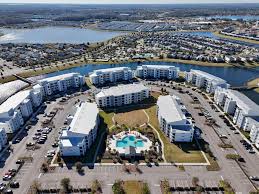 Aerial view of a waterfront resort community with pool and spacious grounds