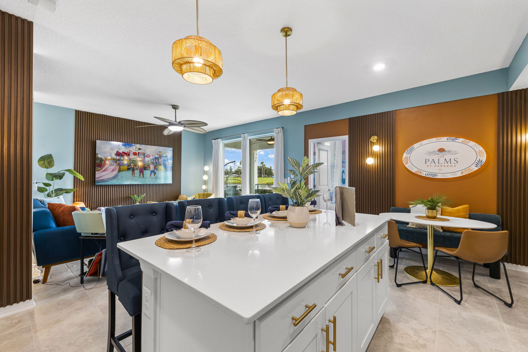 Stylish open living space with oversized island, lounge seating, and dining nook