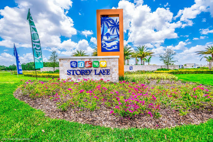 Storey Lake entrance with lush landscaping and sunny Florida skies