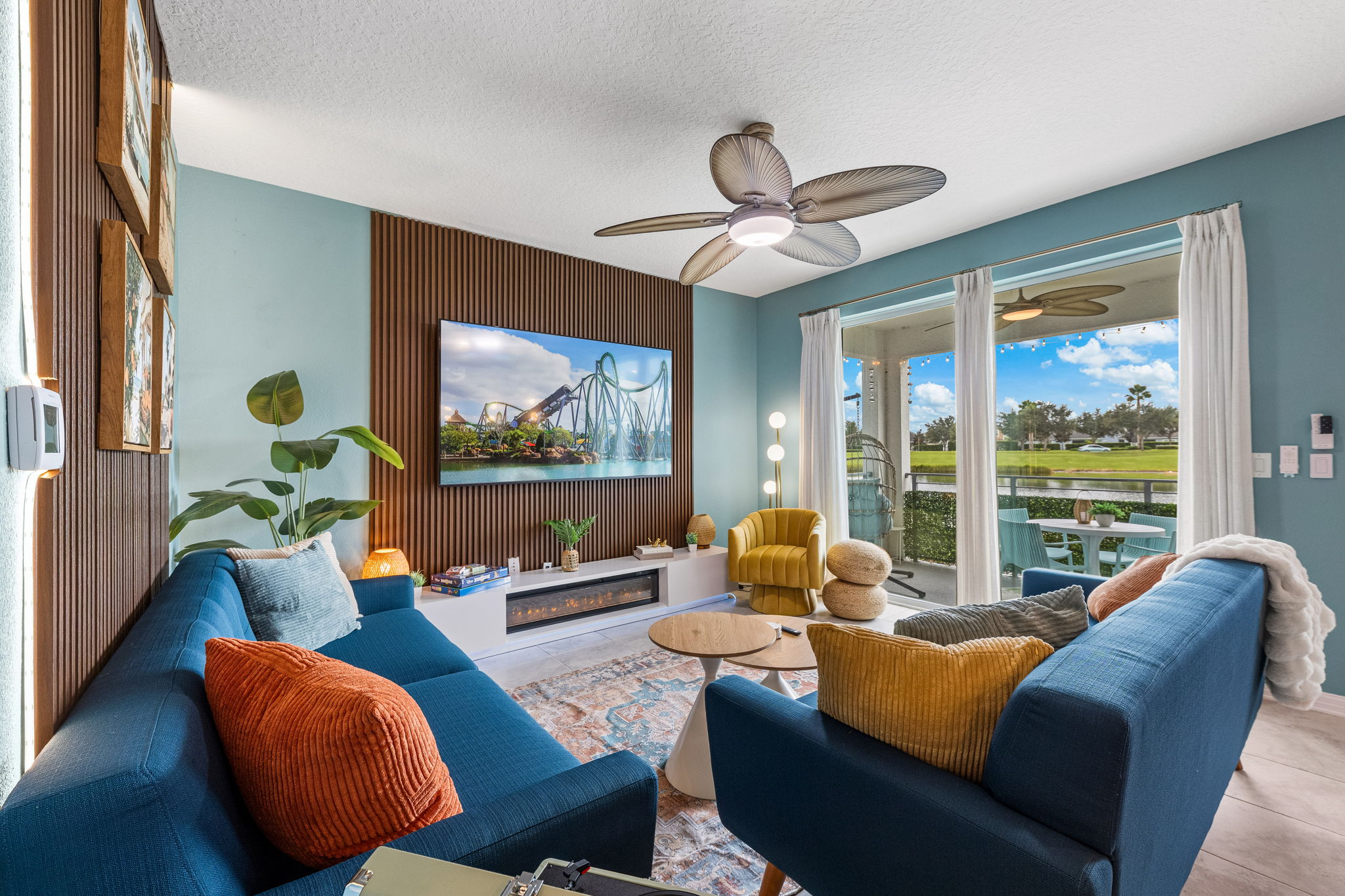 Bright modern lounge with patio access and serene golf course views