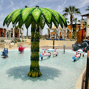 Family-friendly splash pool with palm fountain and playful water features