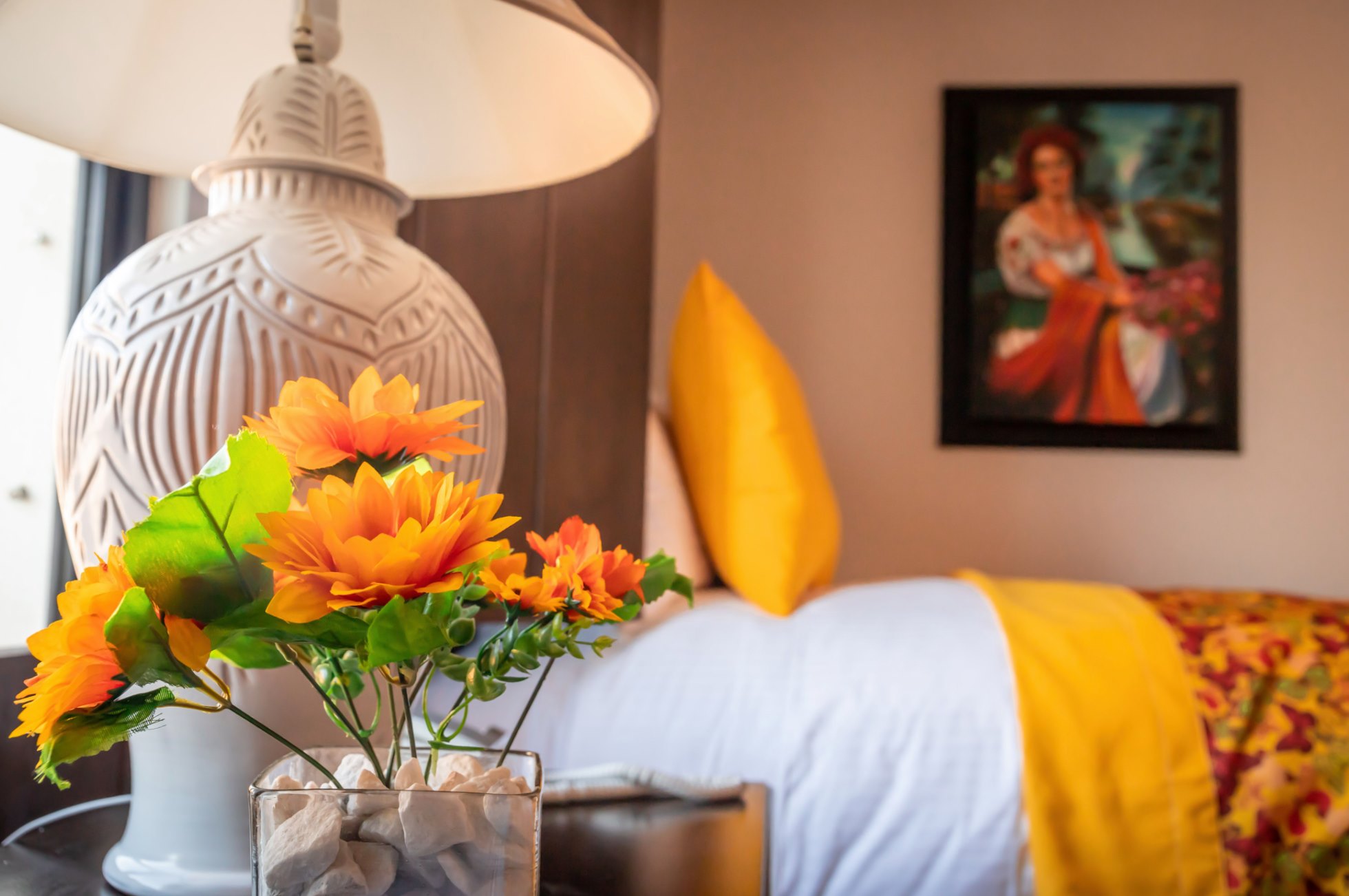 Cozy bedroom with bold yellow accents and cheerful floral decor