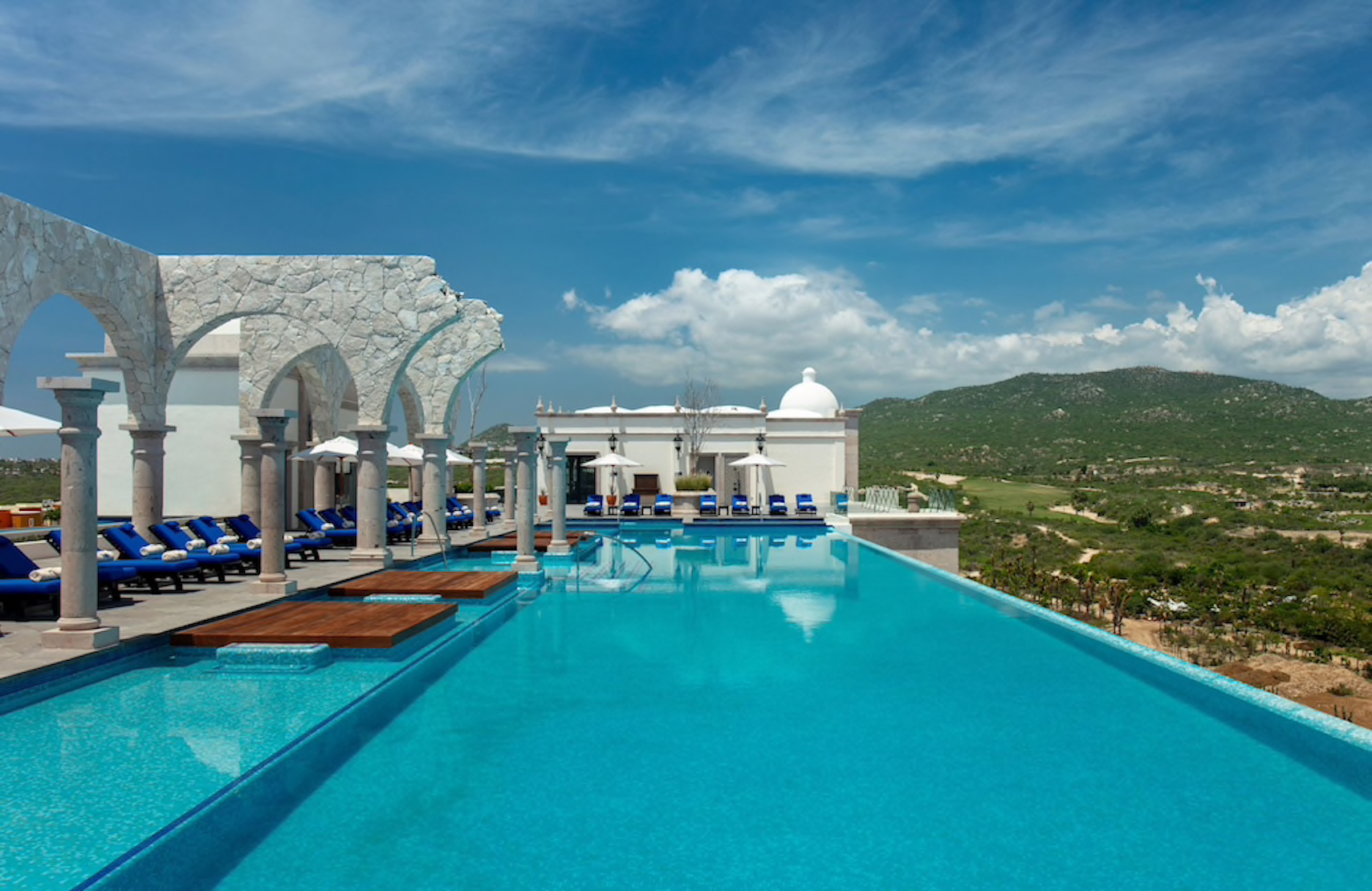 Spectacular infinity pool with stone arches and panoramic hillside views