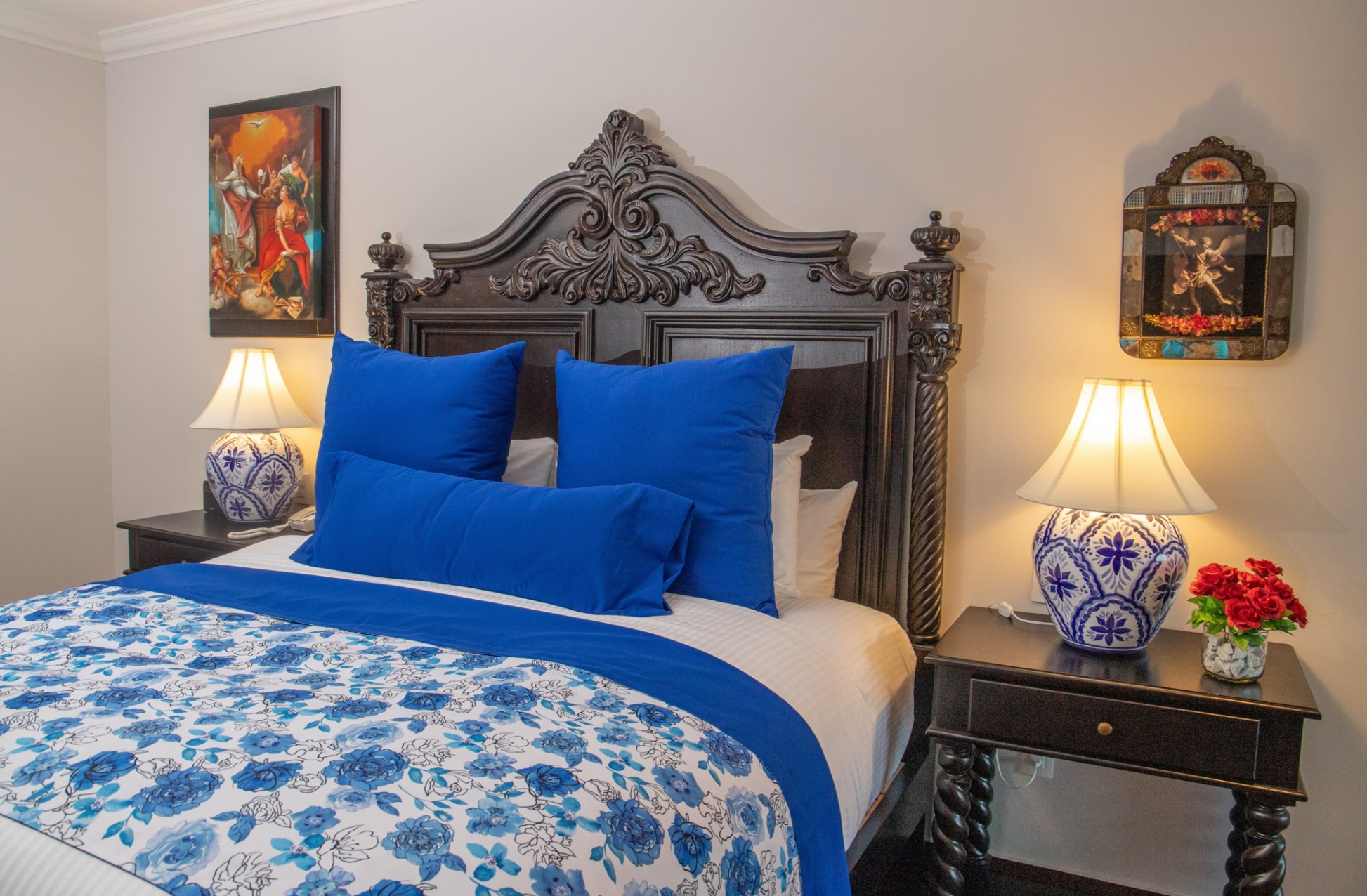 Elegant bedroom with ornate wood bed and vibrant blue accents