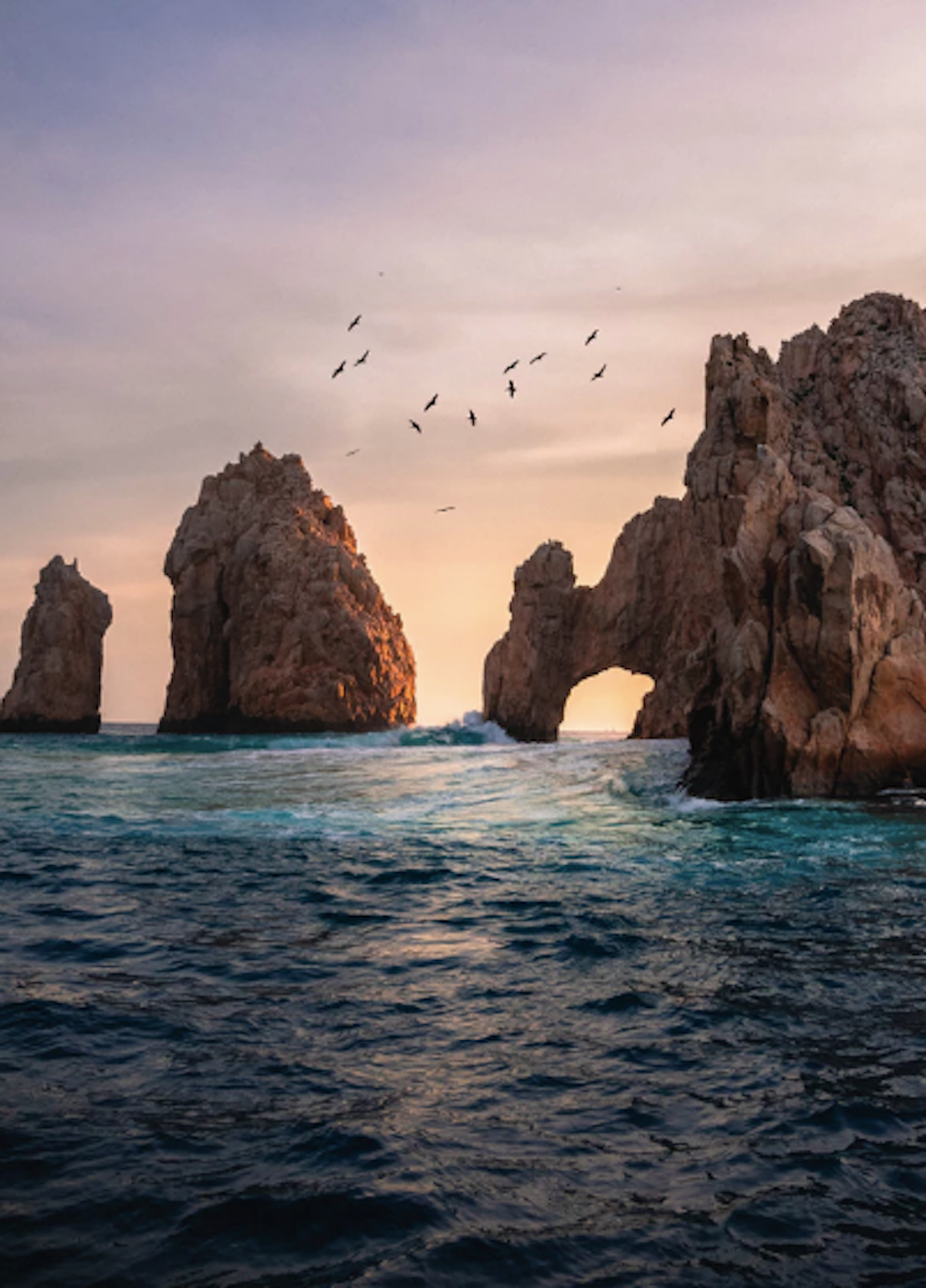 Stunning sunset views over iconic ocean arches and dramatic coastal cliffs